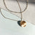 Villanova V Necklace shown in gold with Link Chain laydown
