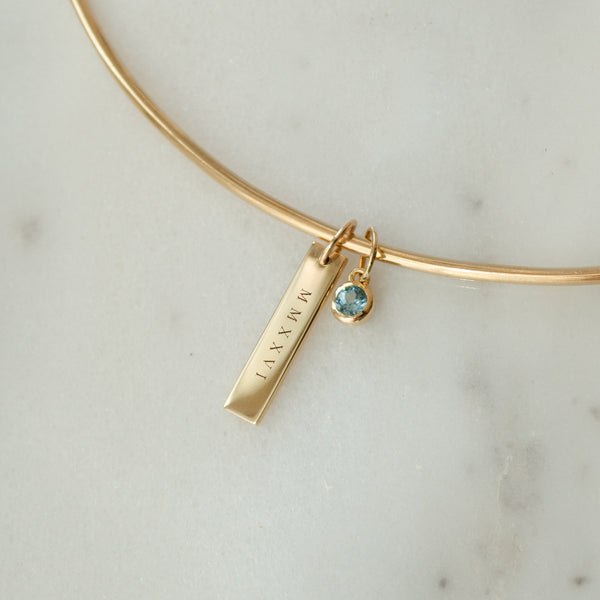 2026 Grad Layering Bar shown on Neck Collar with Blue Topaz Gemstone in gold