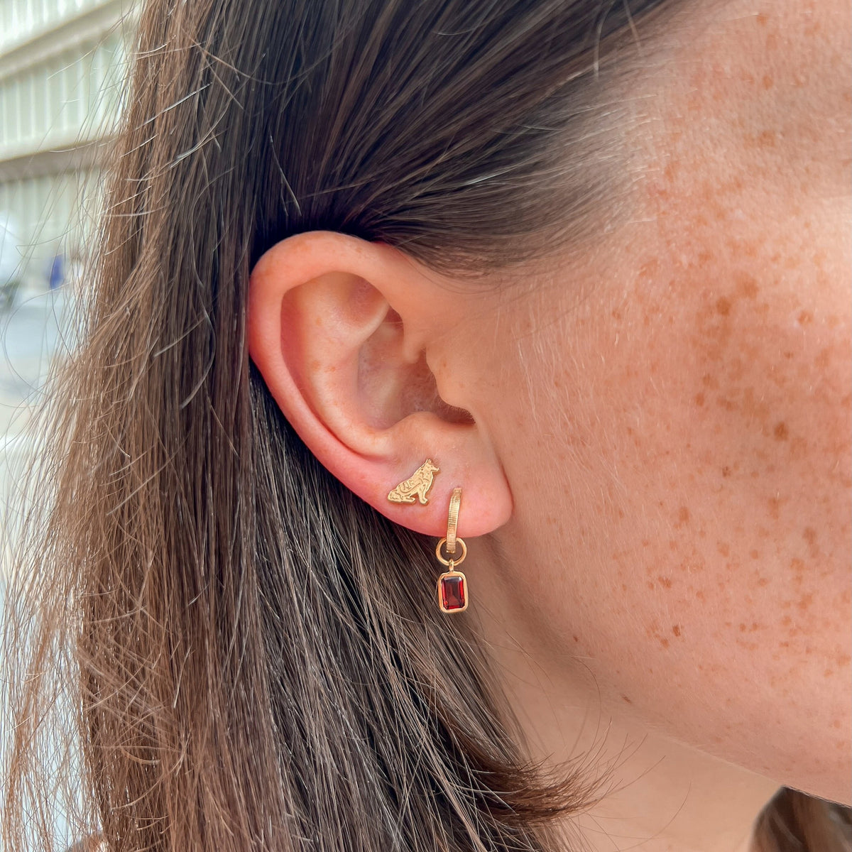 Texas A&M Reveille Stud Earring shown on figure in gold with Garnet Florentine Earring Bundle