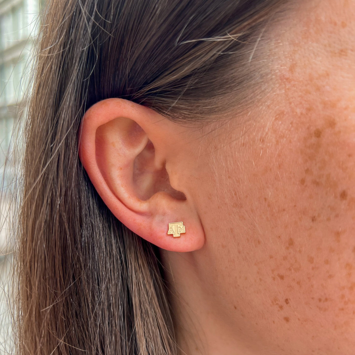 Texas A&M Logo Stud Earring shown on figure in gold