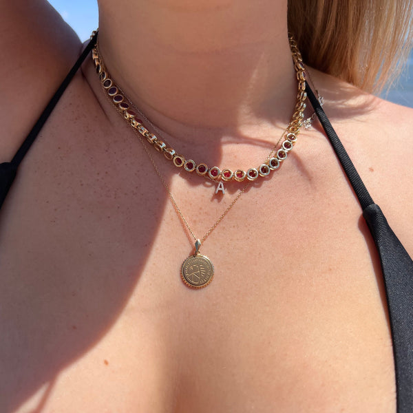 Purdue Sunburst Pendant shown on figure in gold on Cable Chain