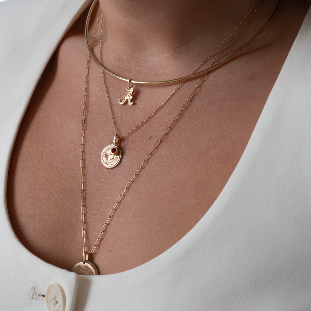 Alabama Logo Charm shown on figure in gold on Neck Collar, with Alabama Sunburst Bundle on Cable Chain