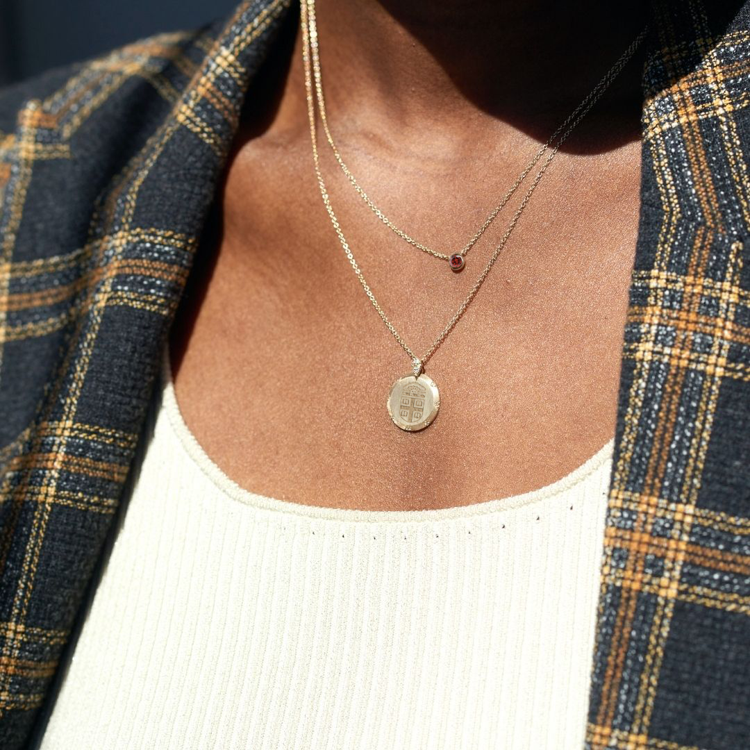 Brown 7-Point Diamond Necklace shown on figure with Garnet Gemstone Necklace