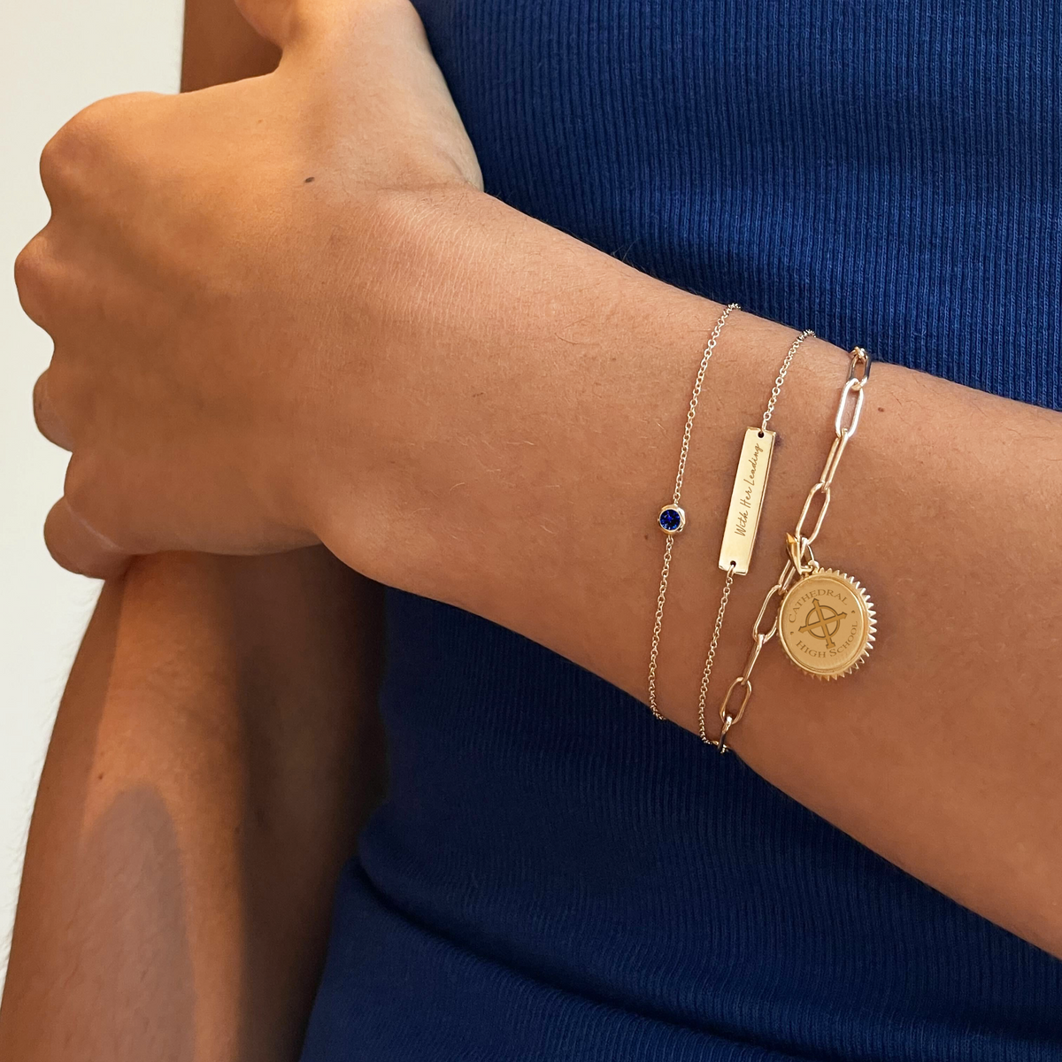 Cathedral Bracelet shown on figure in gold with Sapphire Gemstone Bracelet, and Cathedral Sunburst Pendant on Large Link Bracelet