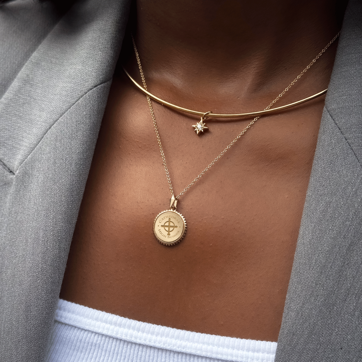 Cathedral Sunburst Pendant shown on figure in gold on Cable Chain with North Star Charm on Neck Collar in gold