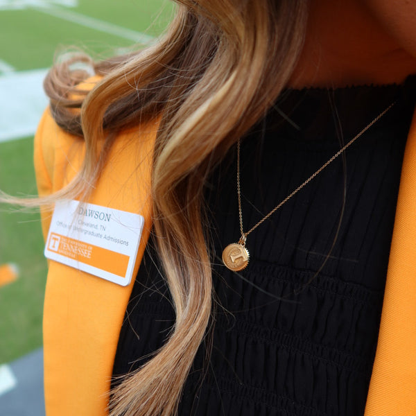 Tennessee Sunburst Pendant shown on figure in gold on Cable Chain with Tennessee Charm