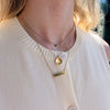 Duke Horizontal Bar Necklace shown on figure in gold with Duke D Necklace in gold