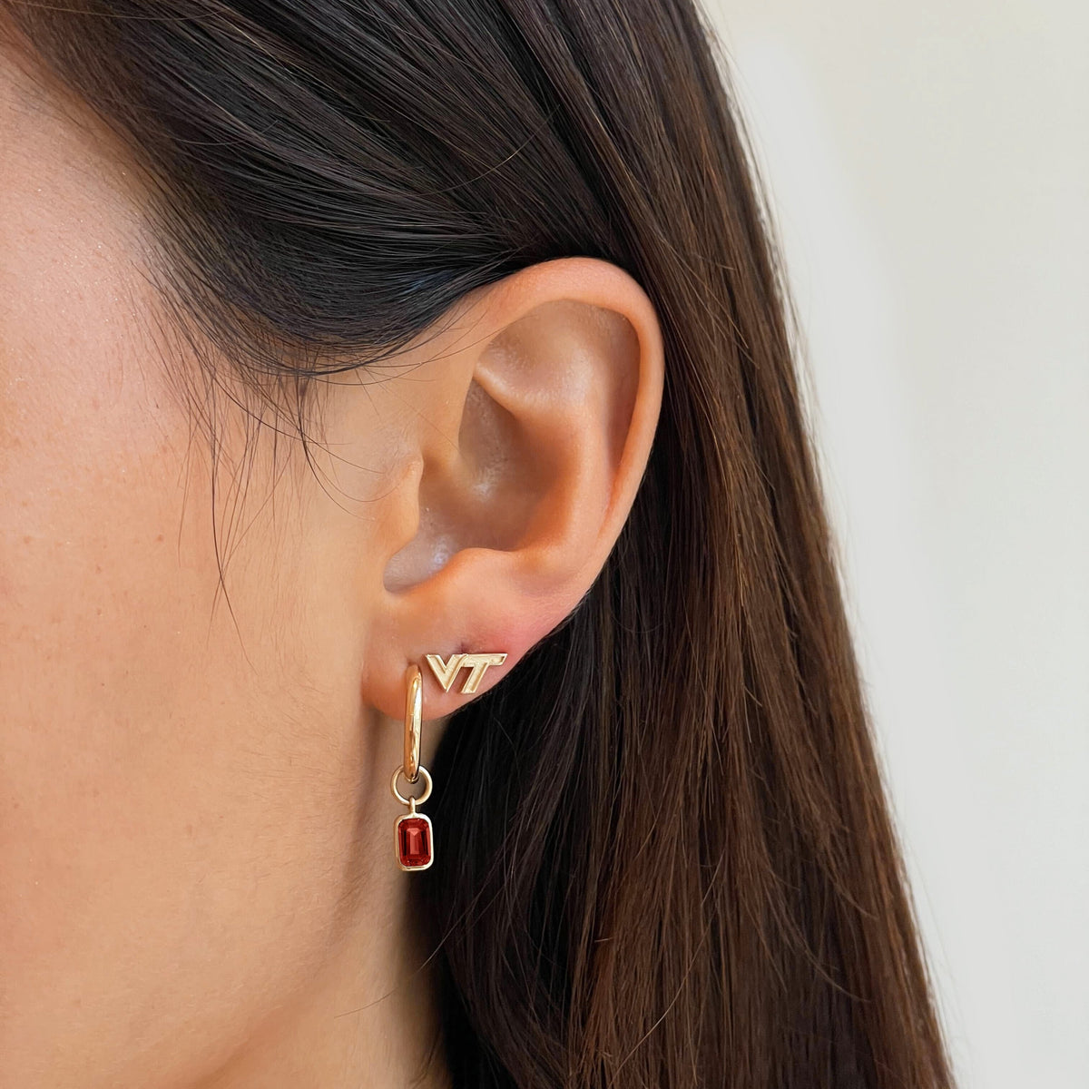 Virginia Tech Mini U Earring Bundle shown on figure in gold