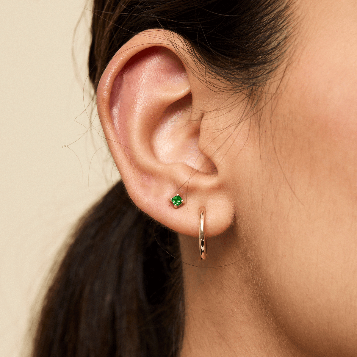3mm Emerald Prong Stud shown on figure in gold