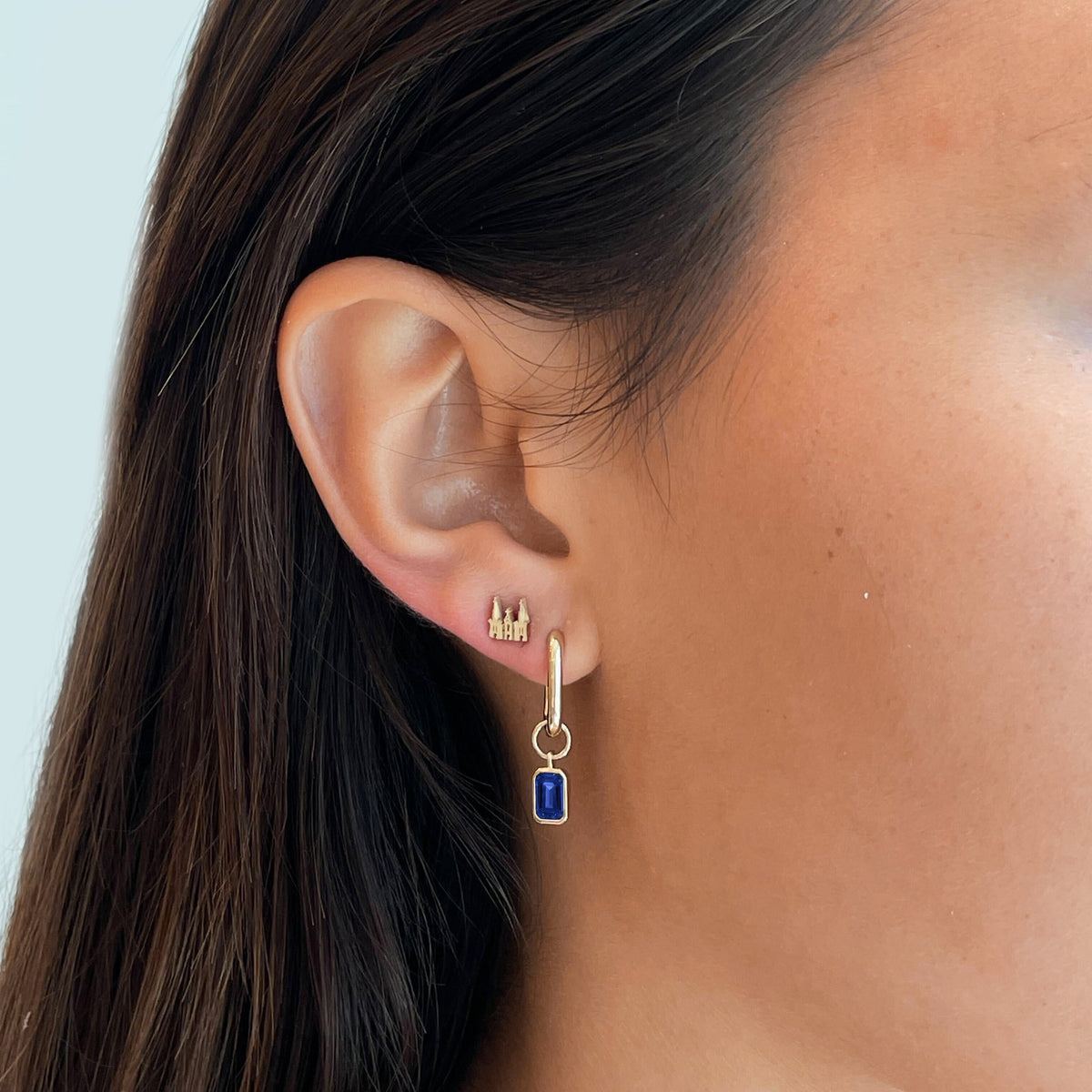 Villanova Church Mini U Earring Bundle shown on figure in gold