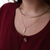 FSU Logo Charm shown on figure in gold on Cable Chain with Neck Collar