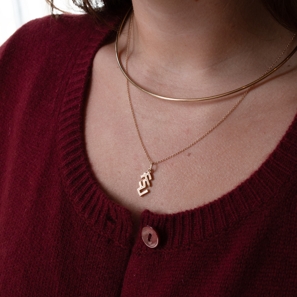 FSU Logo Charm shown on figure in gold on Cable Chain with Neck Collar