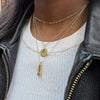 UT Tower Necklace shown on figure in gold with Texas Exes Sunburst and Link Chain Choker