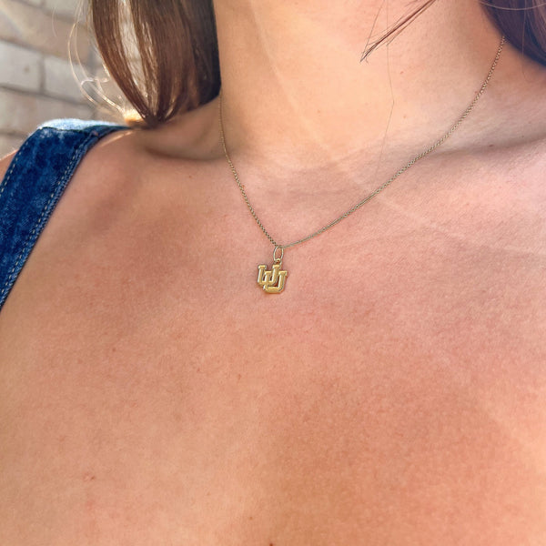 Utah Logo Charm shown on figure in gold on Cable Chain