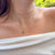 Zeta Tau Alpha Crown Charm shown on figure in gold with Cable Chain and Link Chain Choker