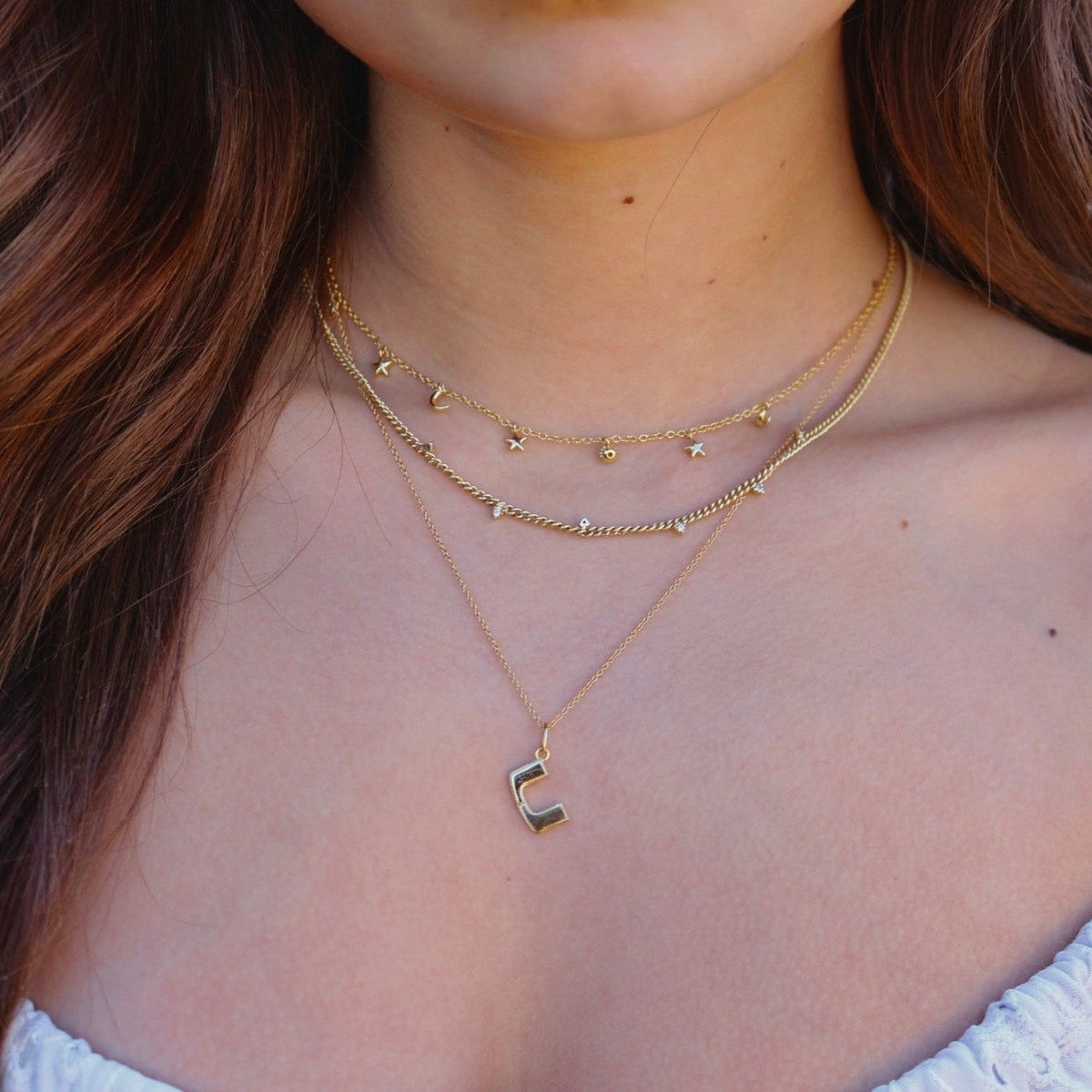 UMiami Letter Charm shown on figure in gold on Cable Chain
