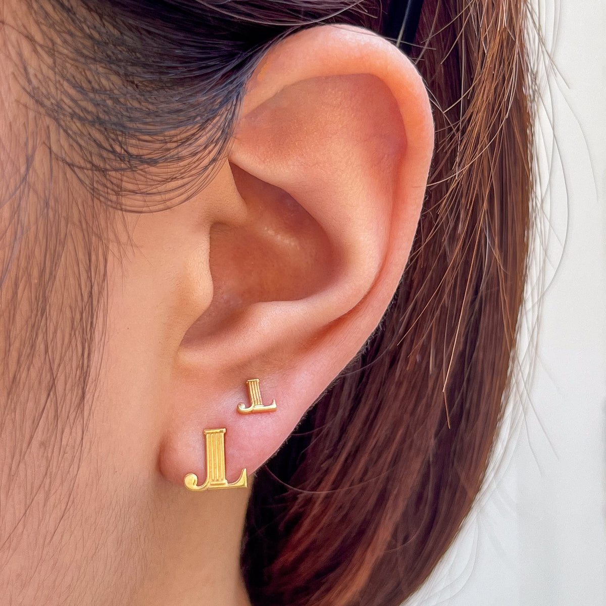 Junior League Stud Earring shown on figure in gold in 2 sizes