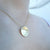 Penn State We Are Necklace shown on figure in gold