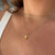 Illinois State Old Main Bell Pendant shown on figure in gold on Cable Chain with Link Chain Choker