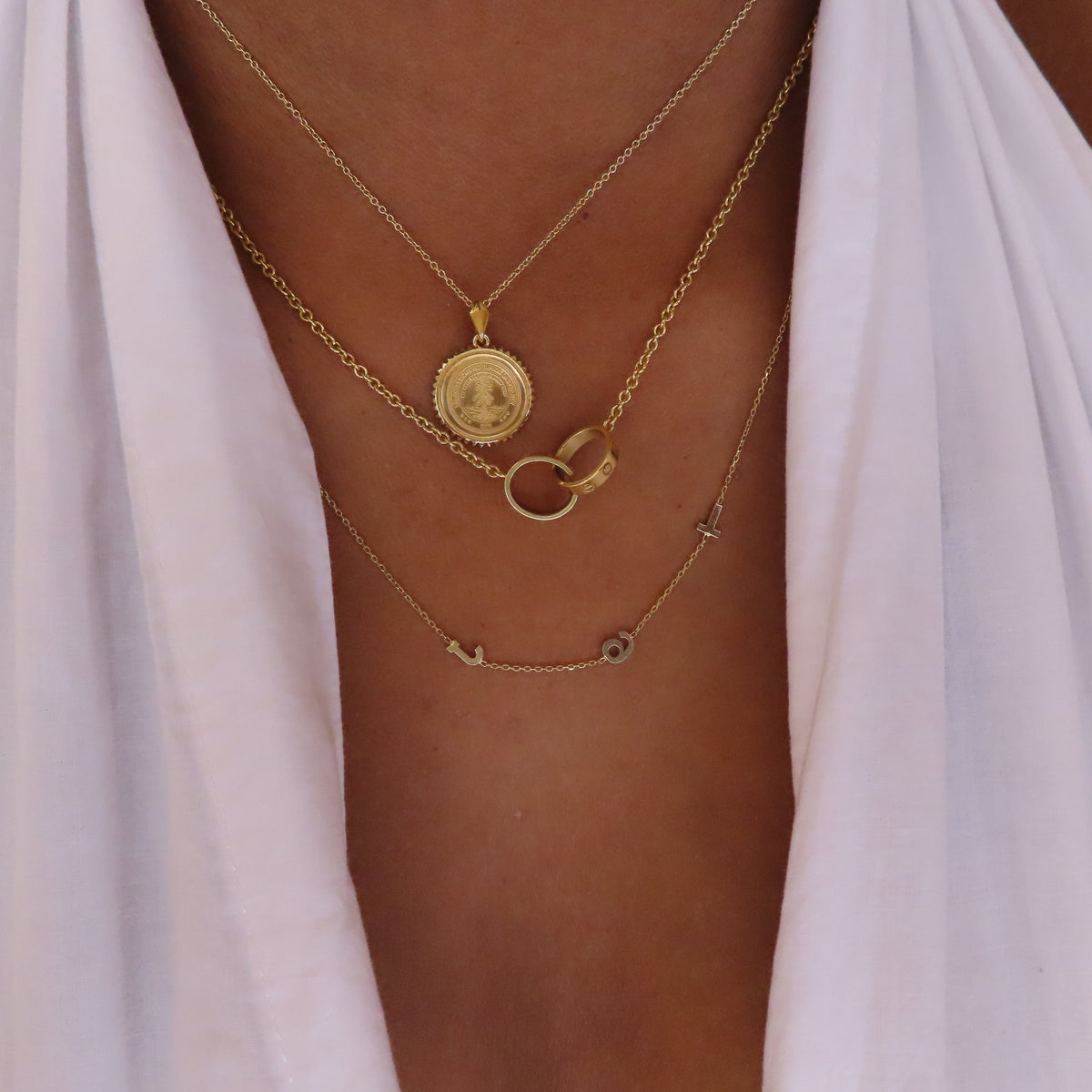 Stanford Sunburst Pendant shown on figure in gold on Cable Chain