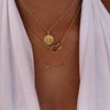 Stanford Sunburst Pendant shown on figure in gold on Cable Chain