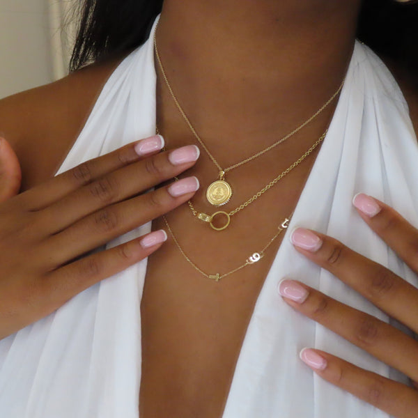 Stanford Sunburst Pendant shown on figure in gold on Cable Chain