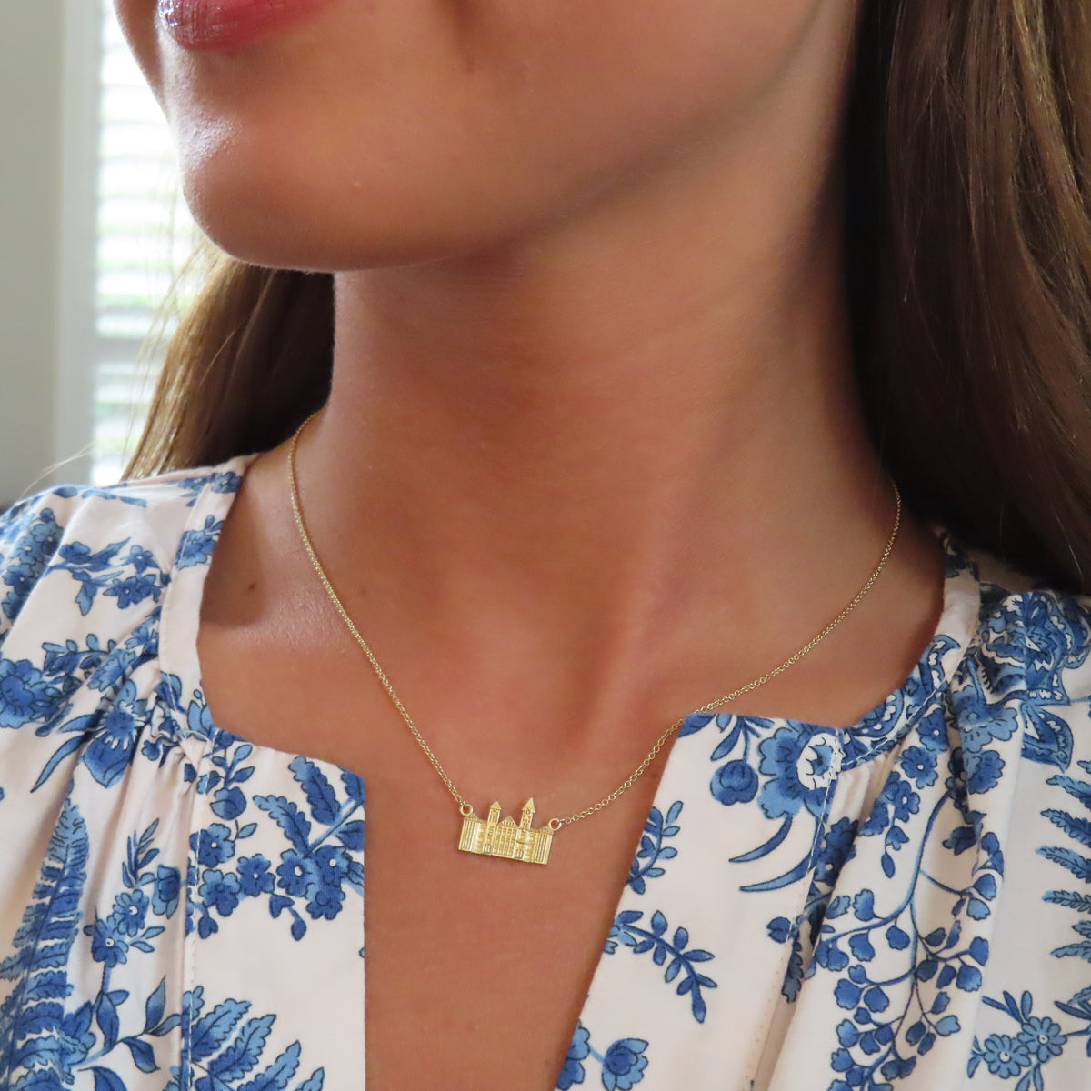 Samford Hall Necklace shown on figure in gold
