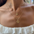 Kansas State Wildcat Charm shown on figure in gold on Cable Chain with Kansas State Sunburst Pant in gold on Link Chain