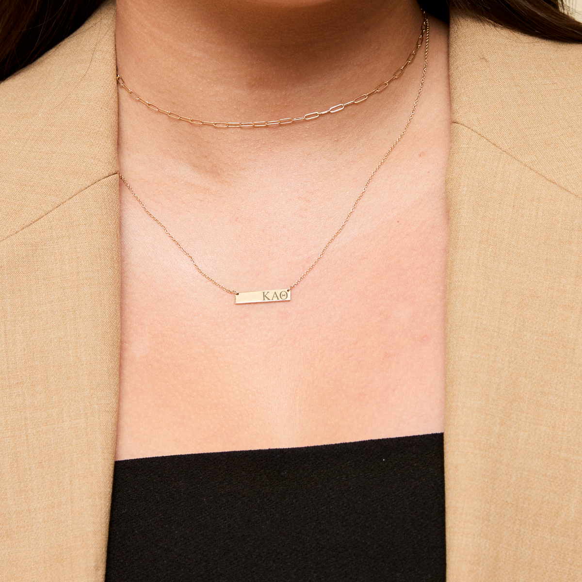 Kappa Alpha Theta Letters Horizontal Bar Necklace shown on figure in gold with Link Chain Choker