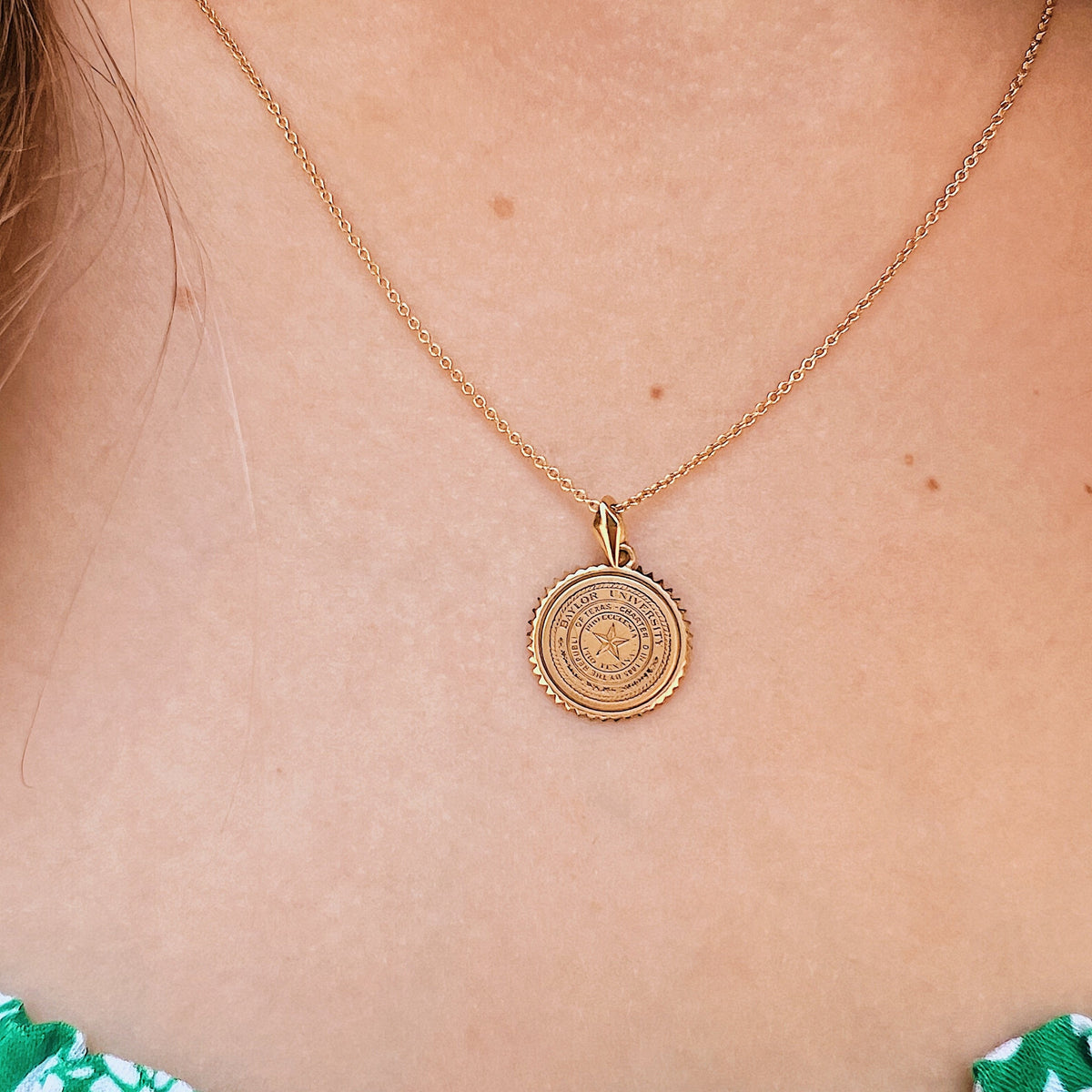 Baylor Sunburst Necklace shown on figure in gold on Cable Chain