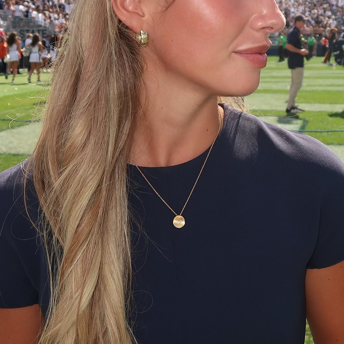 Liberty Logo Organic Petite Necklace shown on figure in gold