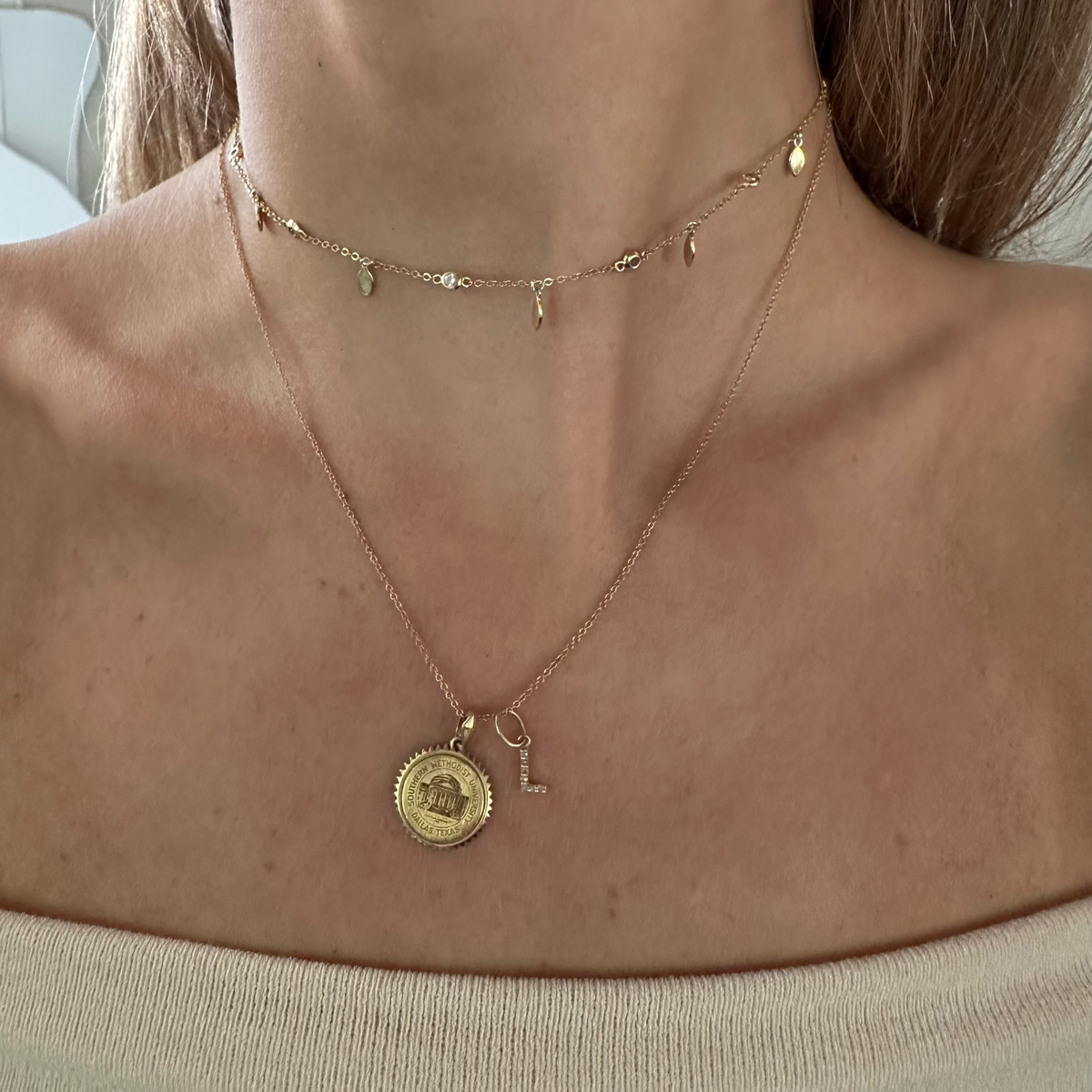 SMU Sunburst Pendant shown on figure in gold on Cable Chain with Diamond Letter