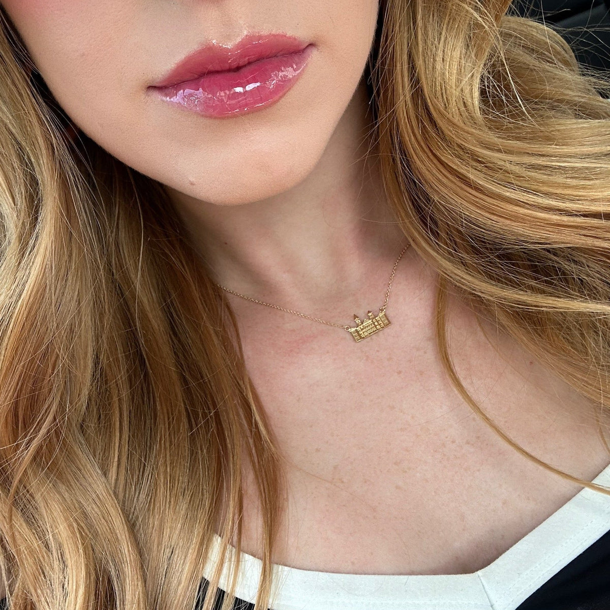 Gold Auburn Samford Hall Necklace, sits on a 15-17in chain