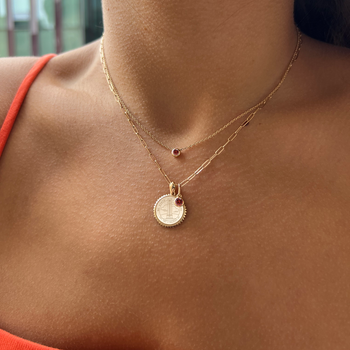 NC State Sunburst Bundle shown on figure in gold with Garnet Gemstone Necklace