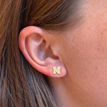 Nebraska Logo Stud Earring shown on figure in gold