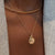 North Star Line Bar Charm shown on figure in gold with Penn State Sunburst on Cable Chain and Neck Collar in gold