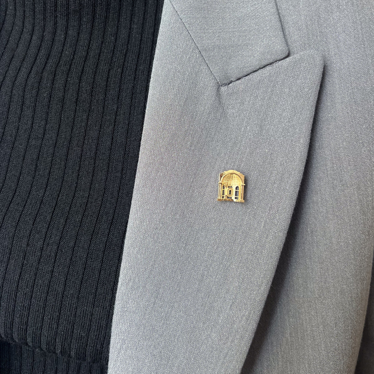 Ohio State Rotunda Lapel Pin shown on figure in gold