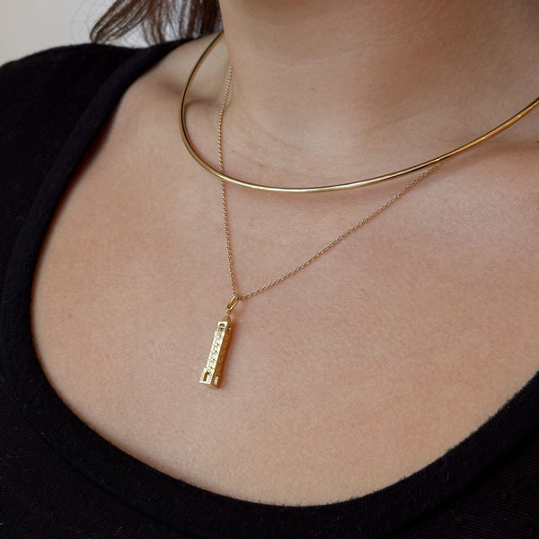 Purdue Bell Tower Pendant shown on figure in gold on Cable Chain with Neck Collar