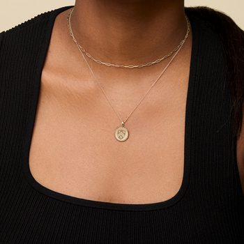 Rice Sunburst Pendant shown on figure in gold on Cable Chain with Link Chain Choker