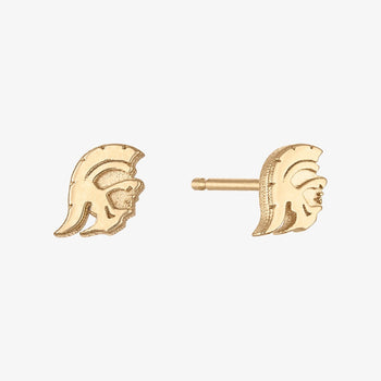 A pair of gold stud earrings shaped like a Spartan helmet, shown on a plain light gray background. One earring is shown from the front, and the other is shown from the side with its post visible.