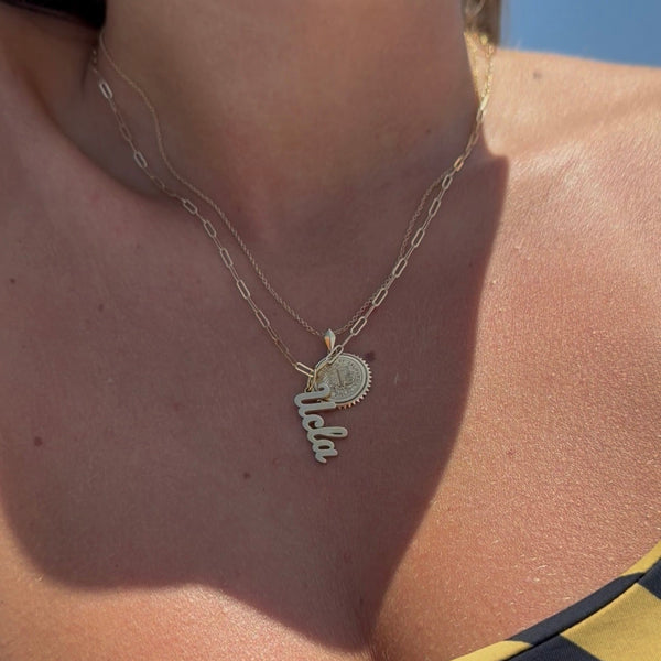 UCLA Logo Charm shown on figure in gold on Link Chain with UCLA Sunburst in gold on Cable Chain