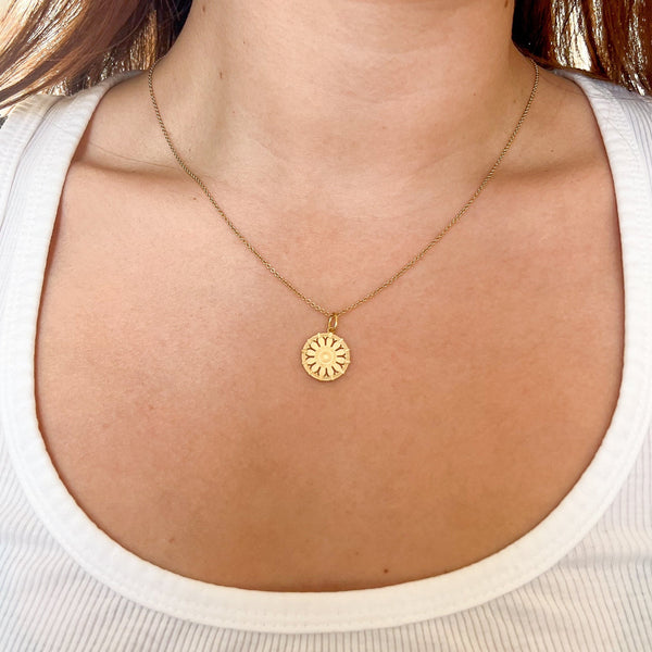 St. Lawrence Herring-Cole Rose Window Pendant shown on figure in gold on Cable Chain