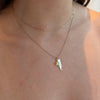 Gold necklace with a star pendant on a person's neck