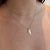 Gold necklace with a star pendant on a person's neck