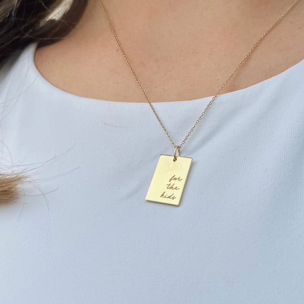 THON "For the Kids" Rectangle Pendant shown on figure in gold on Cable Chain