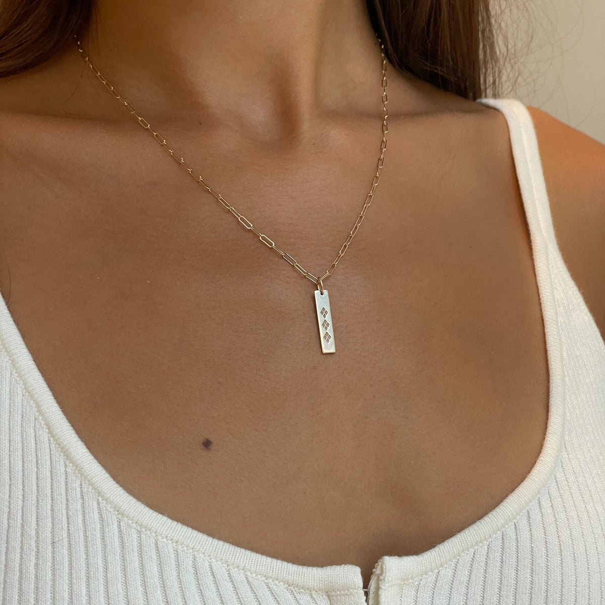 UNC Argyle Bar shown on figure in gold on Link Chain