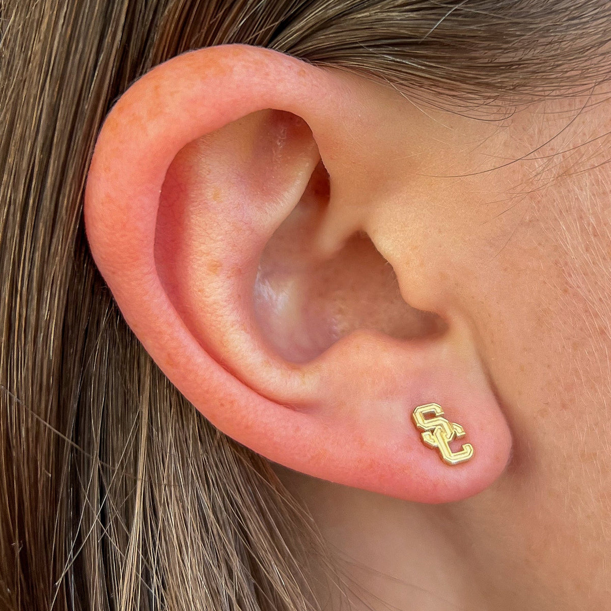 USC Logo Stud shown on figure in gold