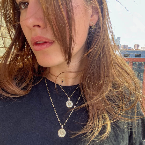 UCONN Sunburst Pendant shown on figure in gold on 22" Link Chain