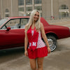 Nebraska Sunburst Bundle shown on figure in gold with Nebraska Logo Charm in gold