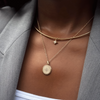North Star Charm shown on figure in gold on Neck Collar with FSU Sunburst on Cable Chain